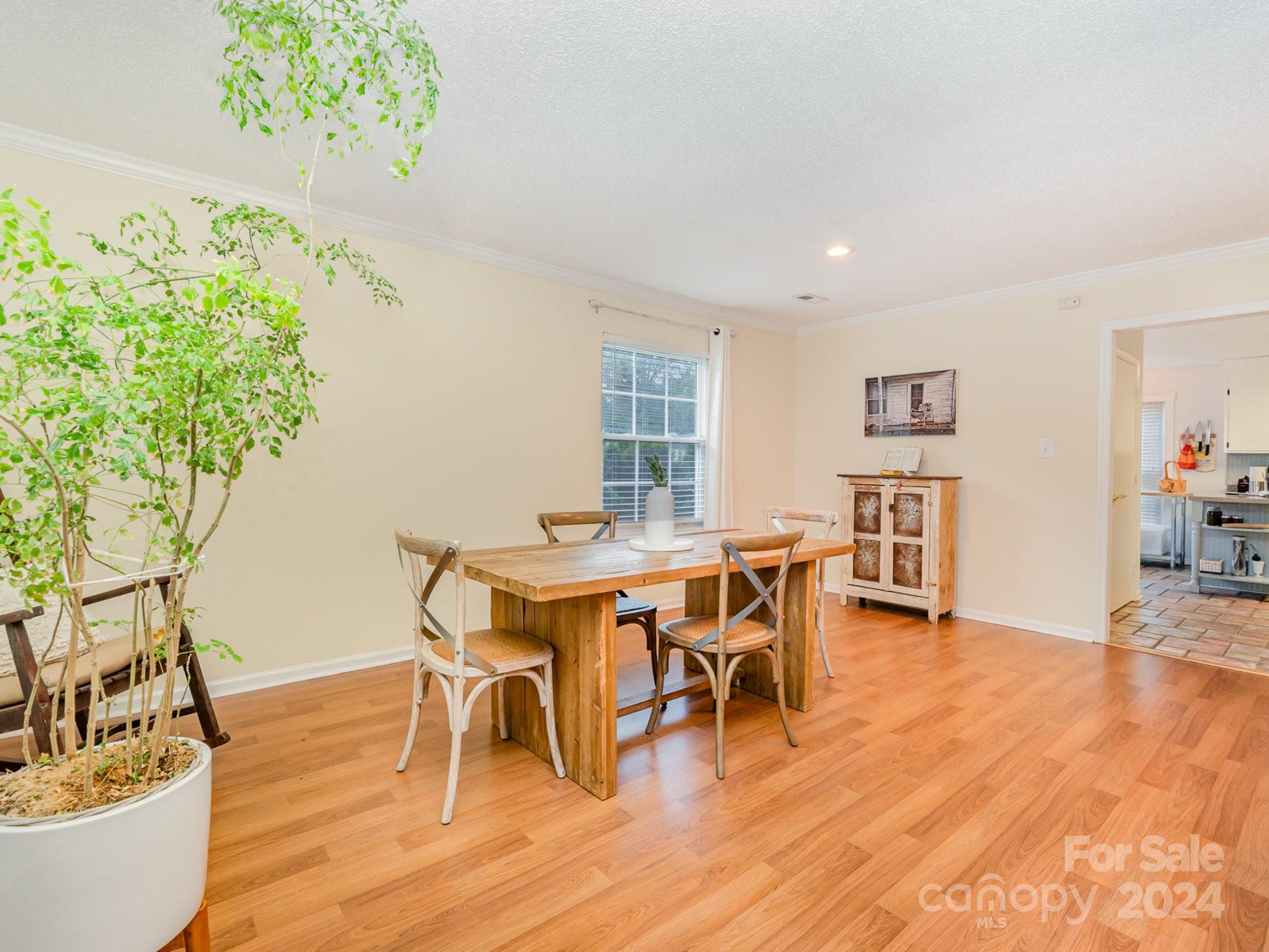 11625 Park Road Charlotte, NC 28226 - Photo 6 of 28 a view of a dining room with furniture and wooden floor