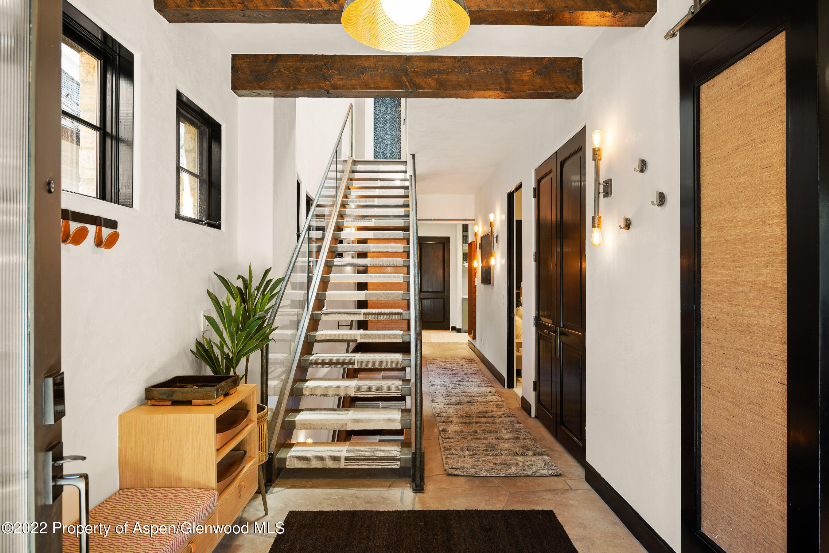 940 East Hyman Avenue Aspen, CO 81611 - Photo 18 of 32 a view of a hallway with wooden floor and windows