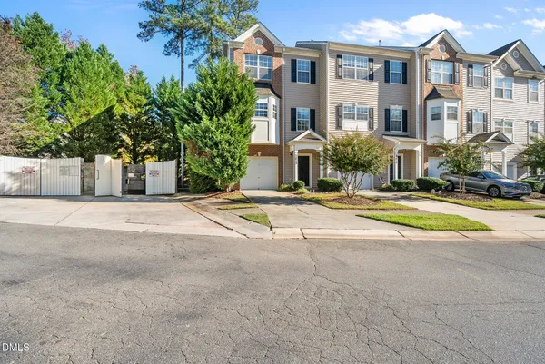a view of white house with a yard