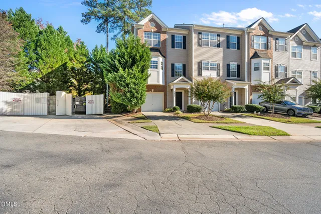 a view of white house with a yard