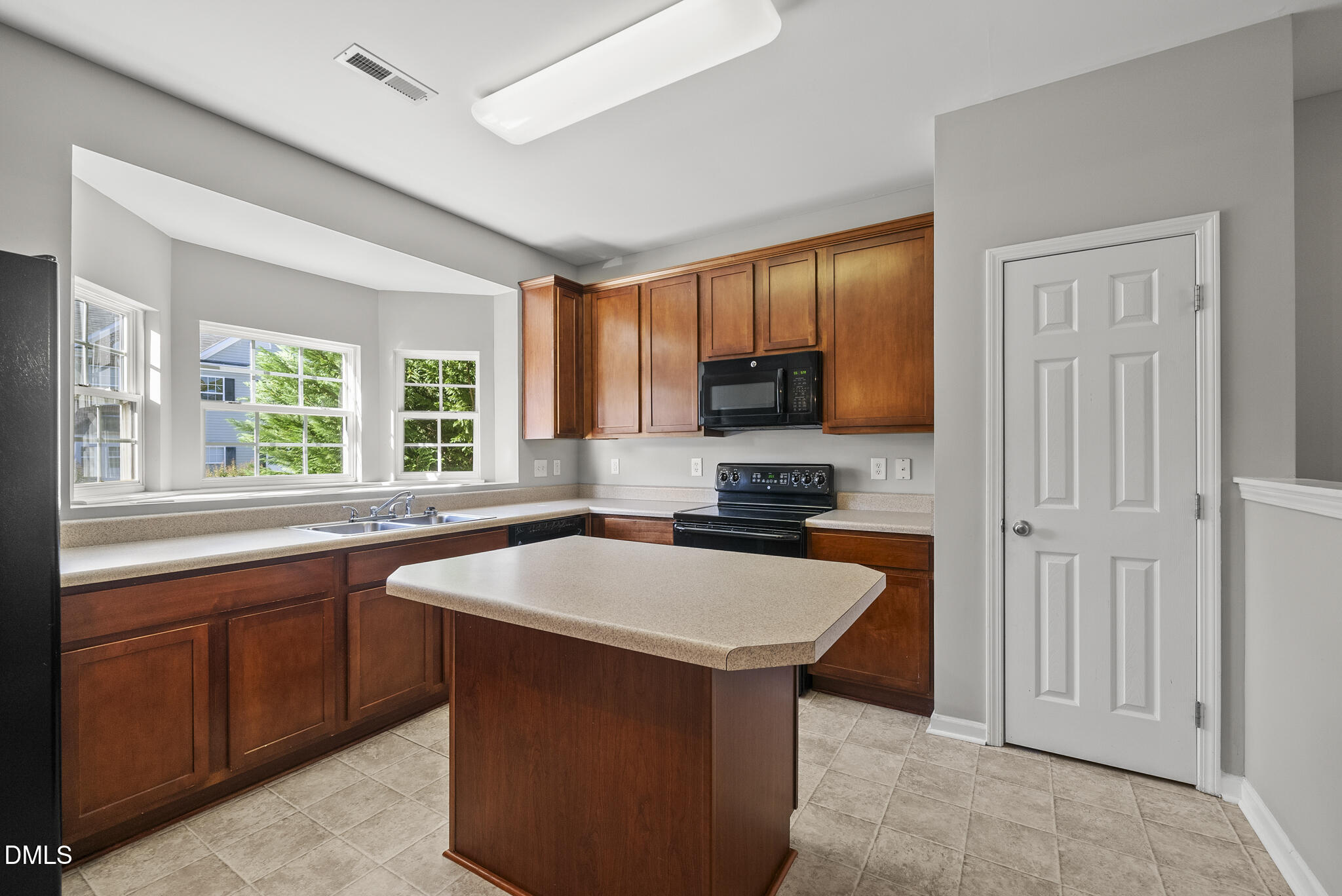 2615 Wyntercrest Lane Durham, NC 27713 - Photo 11 of 34 a kitchen with stainless steel appliances granite countertop a sink stove microwave and window