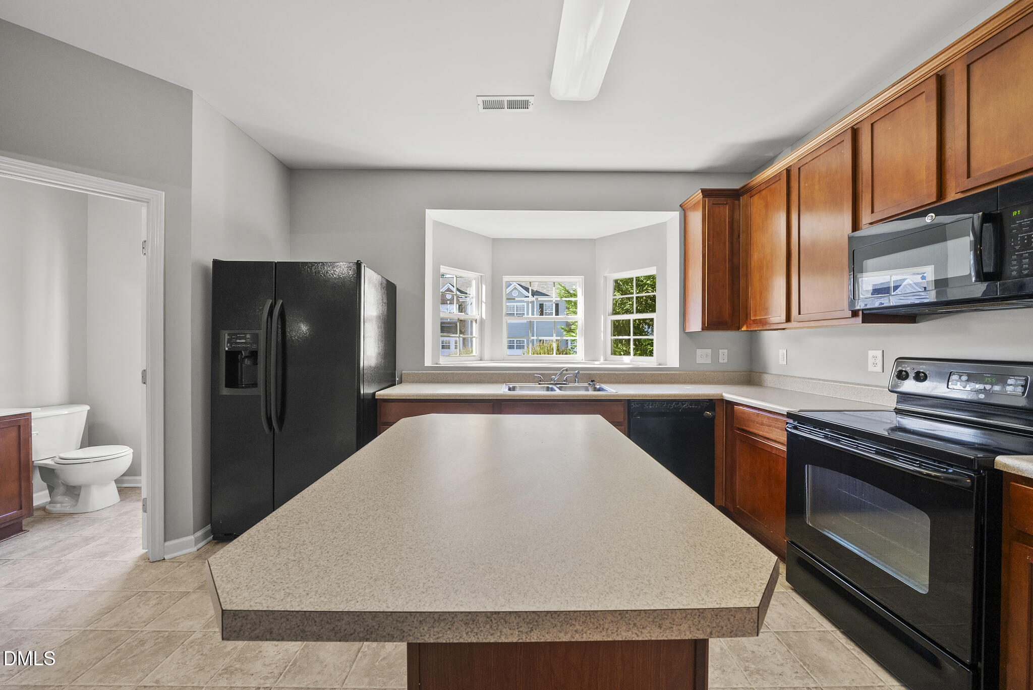 2615 Wyntercrest Lane Durham, NC 27713 - Photo 12 of 34 a kitchen with stainless steel appliances granite countertop a refrigerator a stove top oven a sink and dishwasher
