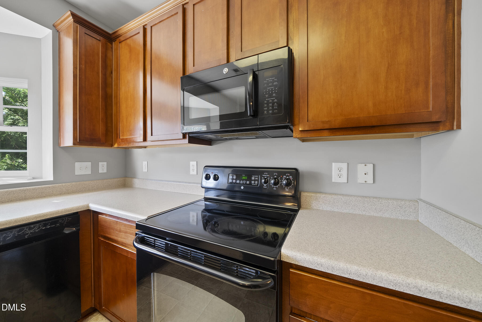 2615 Wyntercrest Lane Durham, NC 27713 - Photo 13 of 34 a kitchen with stainless steel appliances a stove a microwave and sink