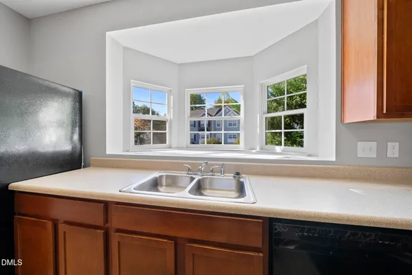 a view of a kitchen counter top space and windows