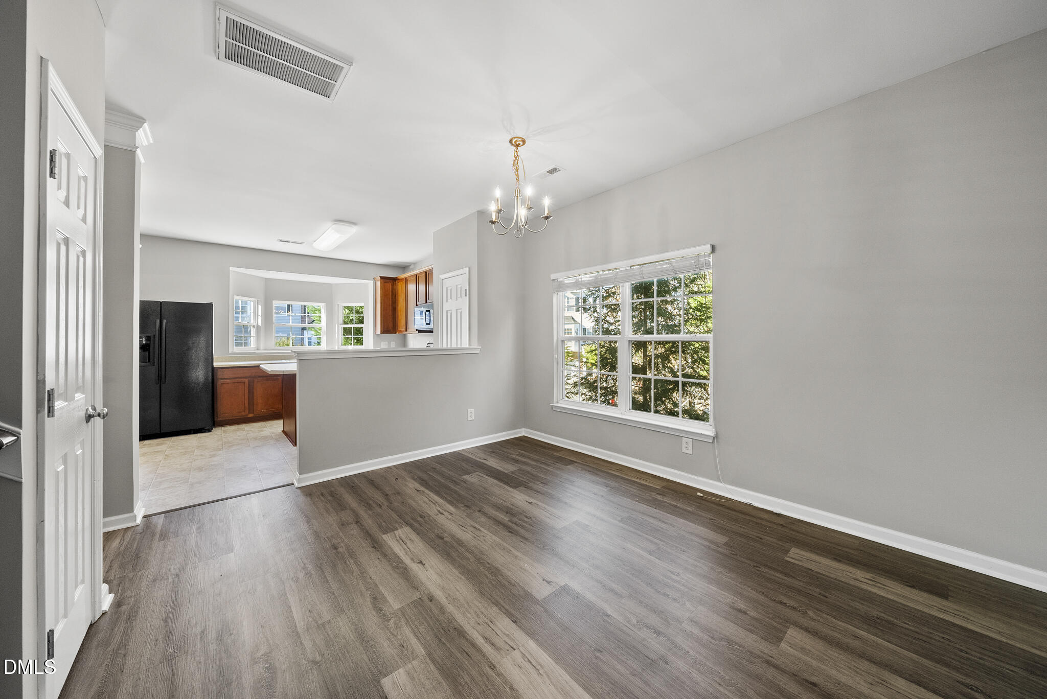 2615 Wyntercrest Lane Durham, NC 27713 - Photo 19 of 34 an empty room with wooden floor fireplace and windows