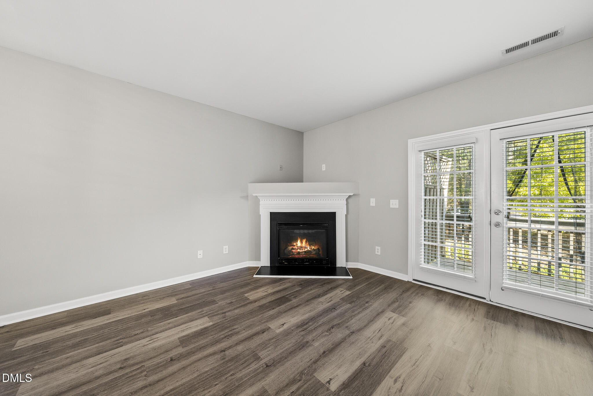 2615 Wyntercrest Lane Durham, NC 27713 - Photo 20 of 34 a view of an empty room with wooden floor fireplace and a window