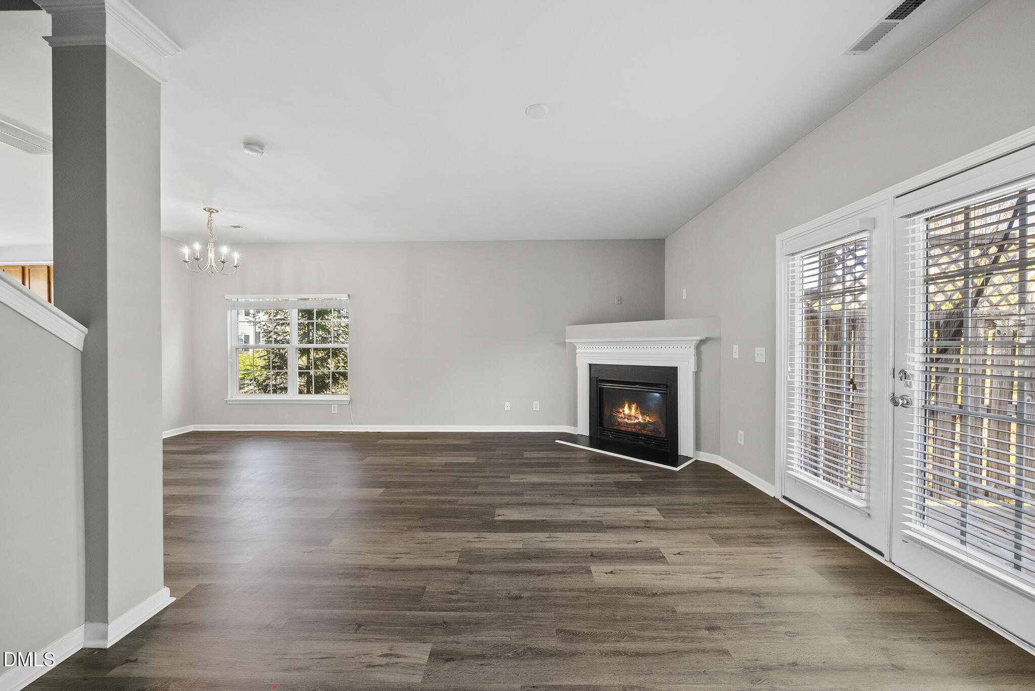 2615 Wyntercrest Lane Durham, NC 27713 - Photo 21 of 34 a view of an empty room with wooden floor fireplace and a window