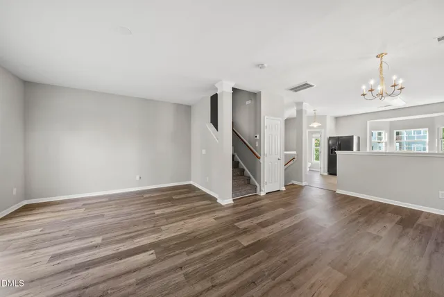 a view of a livingroom with wooden floor and a ceiling fan