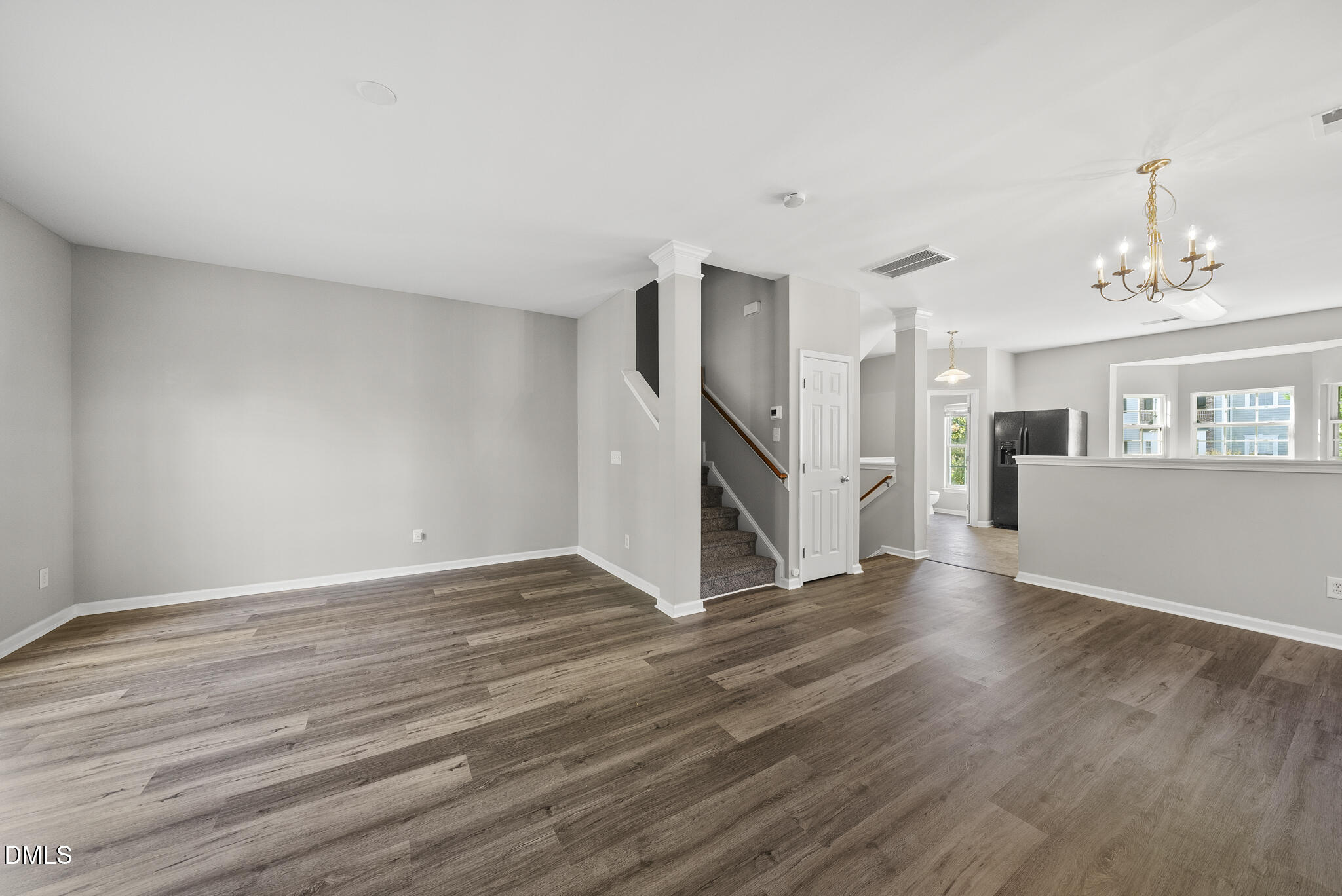 2615 Wyntercrest Lane Durham, NC 27713 - Photo 22 of 34 a view of a livingroom with wooden floor and a ceiling fan