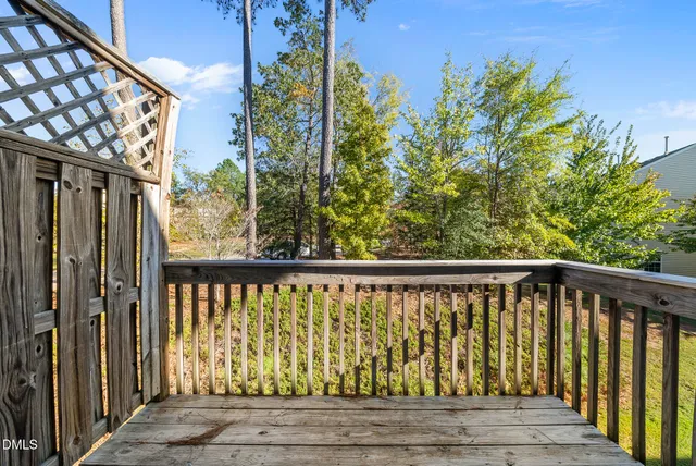 a view of roof deck with wooden floor and fence