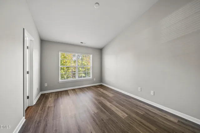 a view of room with window and hardwood floor