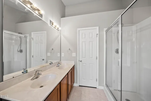 a bathroom with a double vanity sink and a mirror