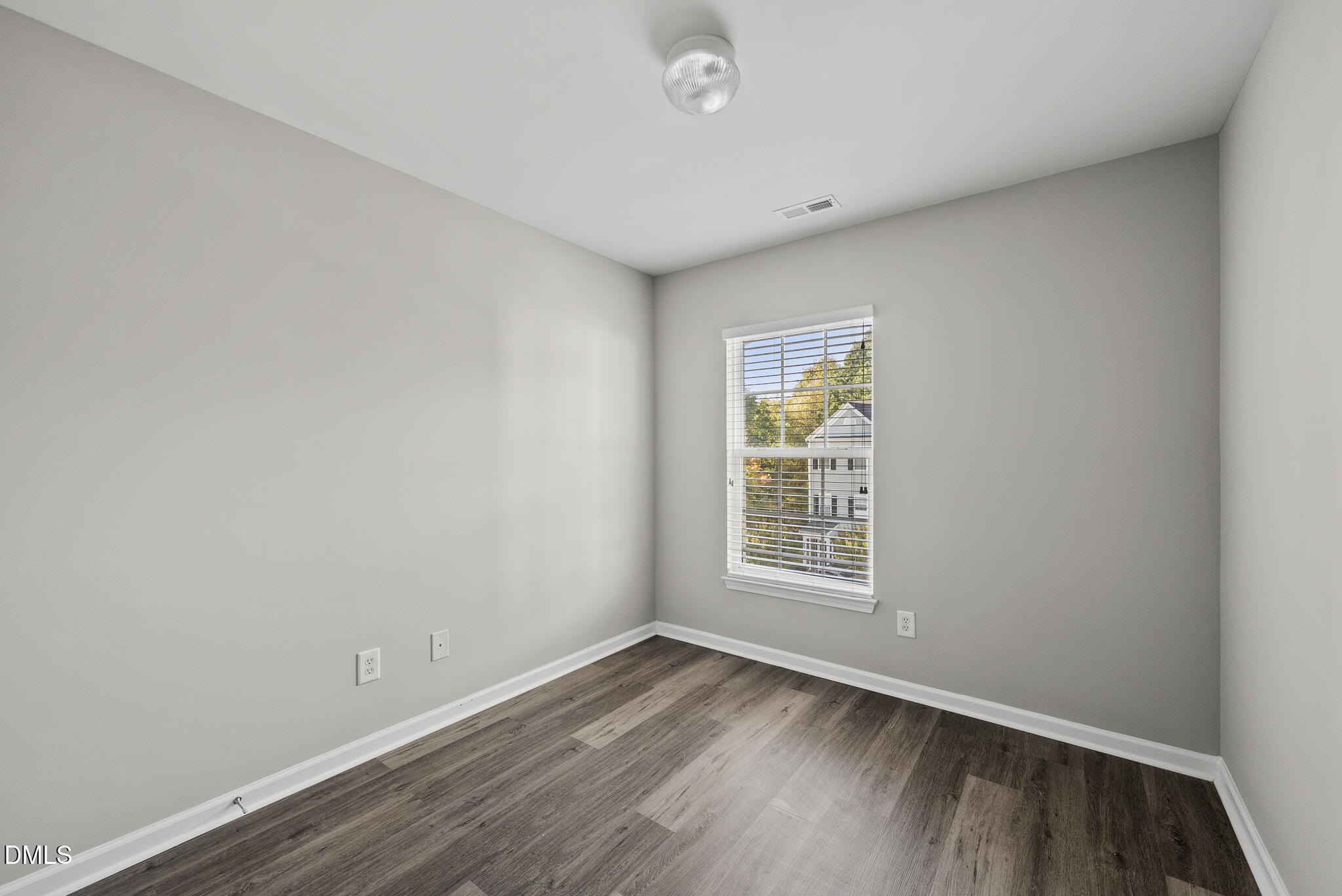 2615 Wyntercrest Lane Durham, NC 27713 - Photo 32 of 34 an empty room with wooden floor and windows