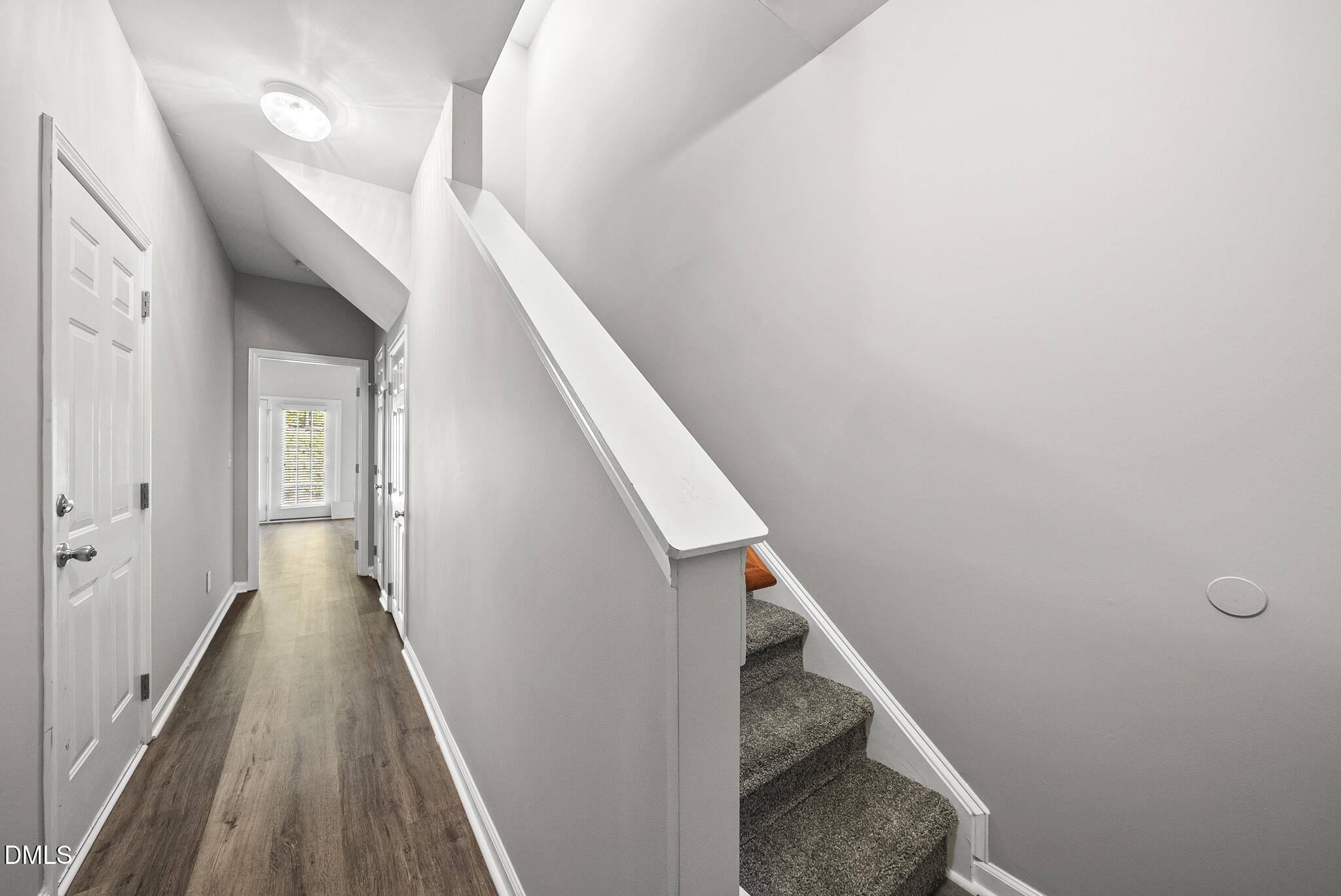 2615 Wyntercrest Lane Durham, NC 27713 - Photo 5 of 34 a view of a hallway with wooden floor and stairs