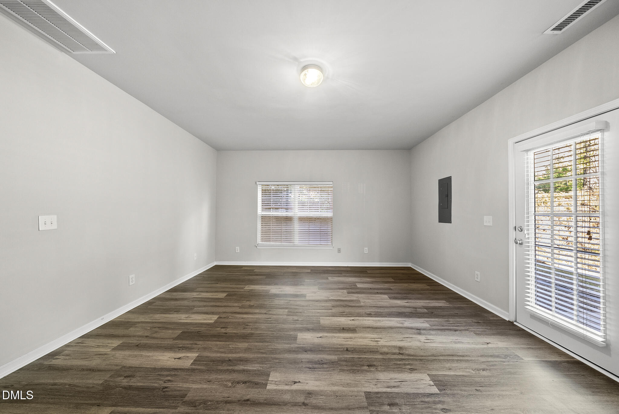 2615 Wyntercrest Lane Durham, NC 27713 - Photo 7 of 34 a view of an empty room with wooden floor and a window