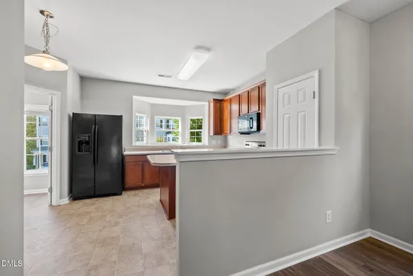 a kitchen with refrigerator and window