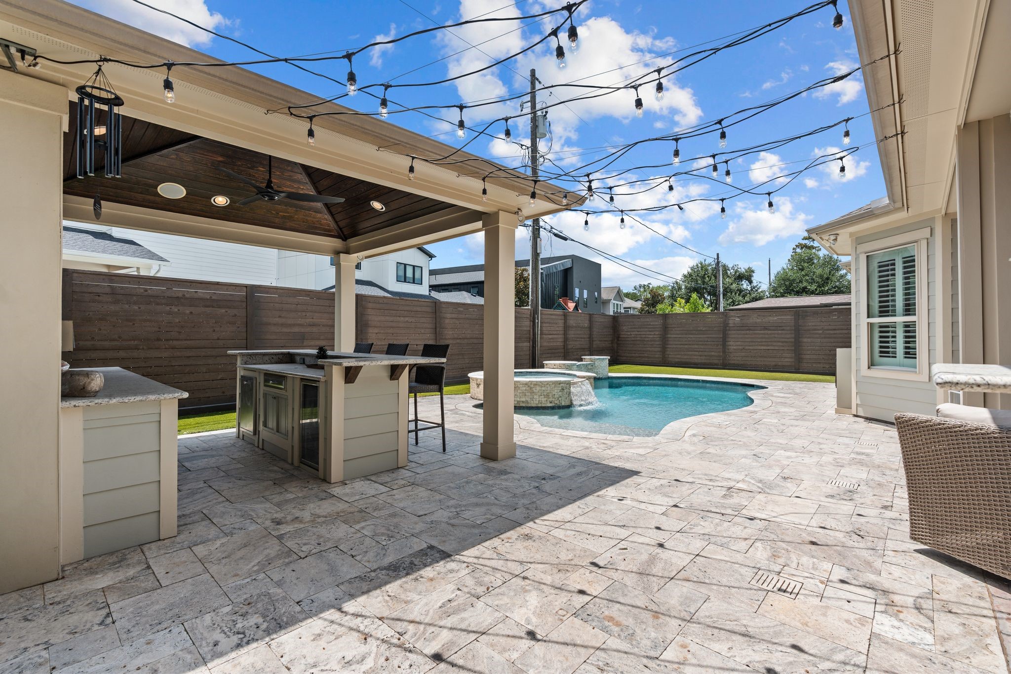 1217 Chippendale Road Houston, TX 77018 - Photo 34 of 42 Designed for year round enjoyment, the reimagined backyard seamlessly connects multiple outdoor living spaces including the covered patio, summer kitchen, pool & spa, cabana, & turfed yard. A dedicated pool bath adds exceptional convenience for both everyday use & entertaining.