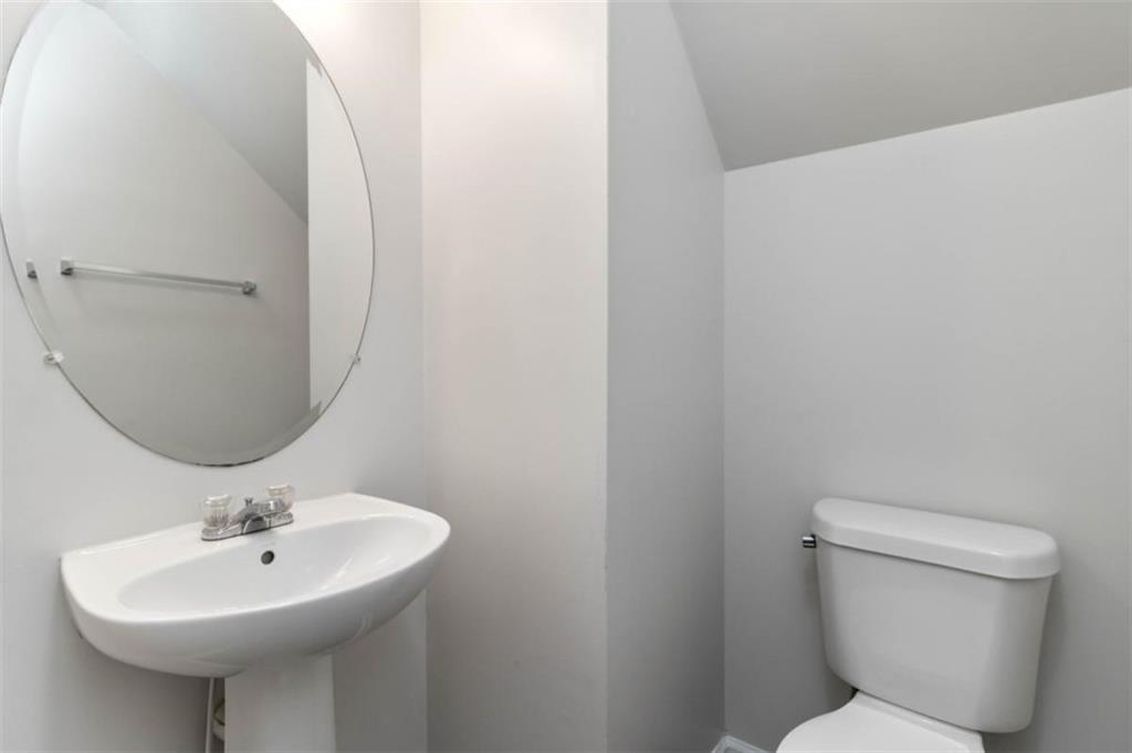 6265 Smoke Ridge Lane Cumming, GA 30041 - Photo 15 of 33 a bathroom with a sink a mirror and a toilet