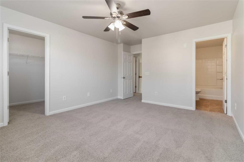 6265 Smoke Ridge Lane Cumming, GA 30041 - Photo 21 of 33 a view of an empty room and a ceiling fan