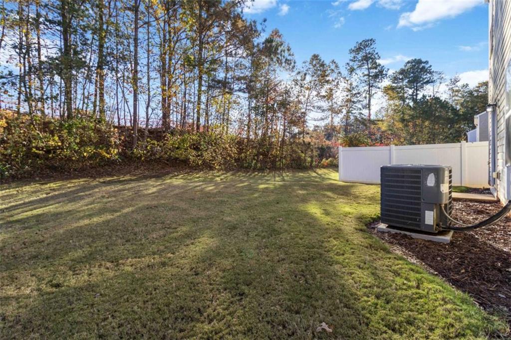 6265 Smoke Ridge Lane Cumming, GA 30041 - Photo 32 of 33 a view of a backyard with large trees