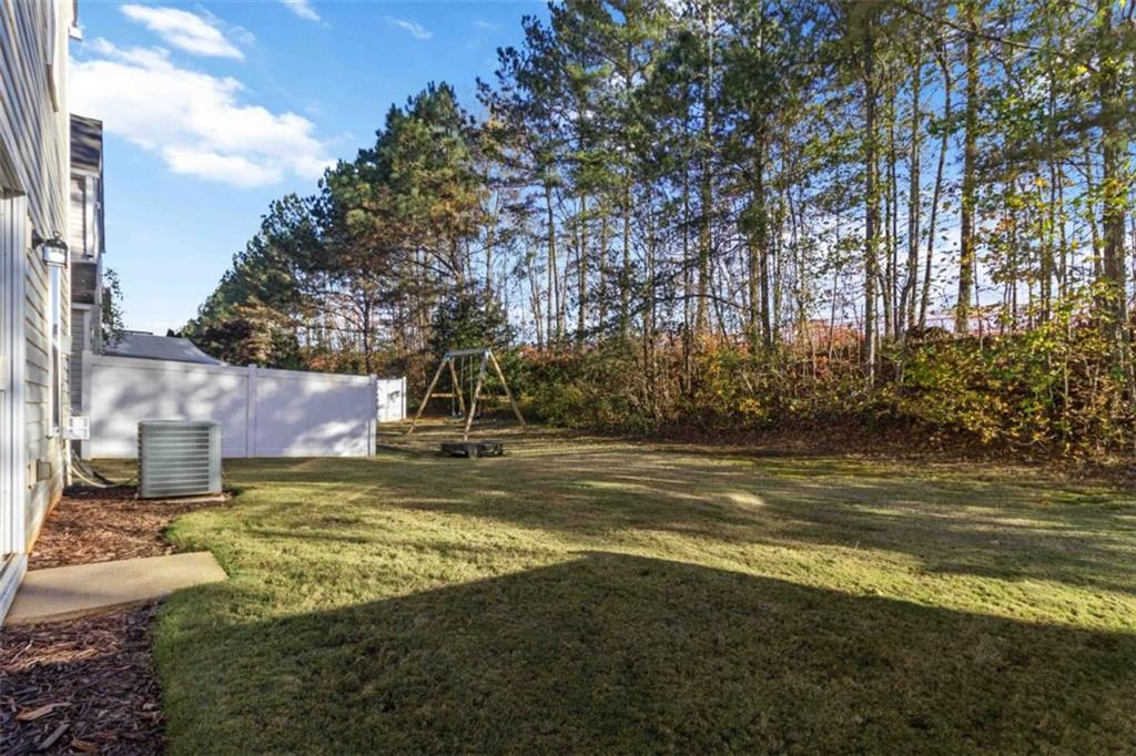 6265 Smoke Ridge Lane Cumming, GA 30041 - Photo 33 of 33 a view of a yard with a house