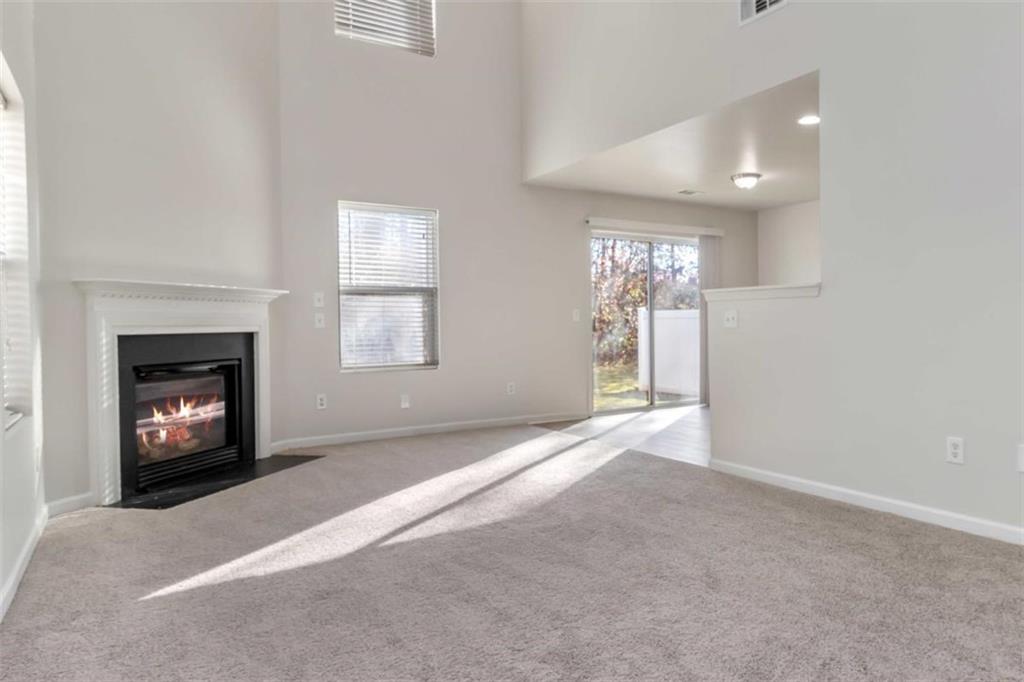 6265 Smoke Ridge Lane Cumming, GA 30041 - Photo 6 of 33 an empty room with windows and fireplace