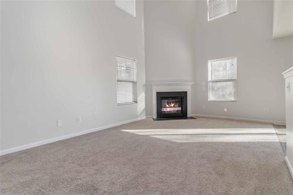 6265 Smoke Ridge Lane Cumming, GA 30041 - Photo 8 of 33 a big room with a fireplace and a window