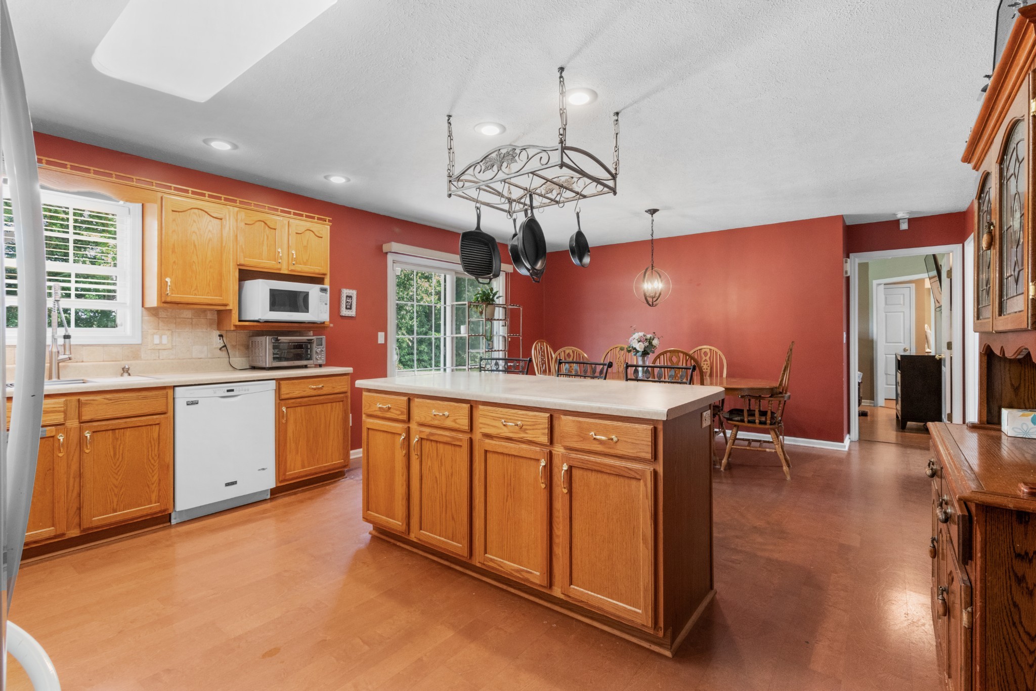 1033 Sivley Road Hopkinsville, KY 42240 - Photo 11 of 23 a kitchen with stainless steel appliances granite countertop a sink dishwasher a stove a dining table and chairs with wooden floor