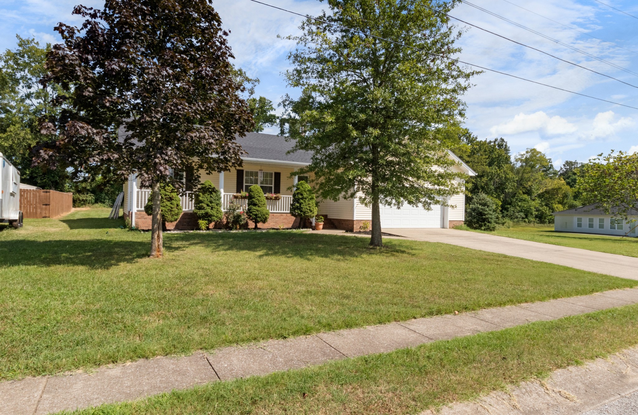 1033 Sivley Road Hopkinsville, KY 42240 - Photo 6 of 23 a view of a big house with a big yard and large trees