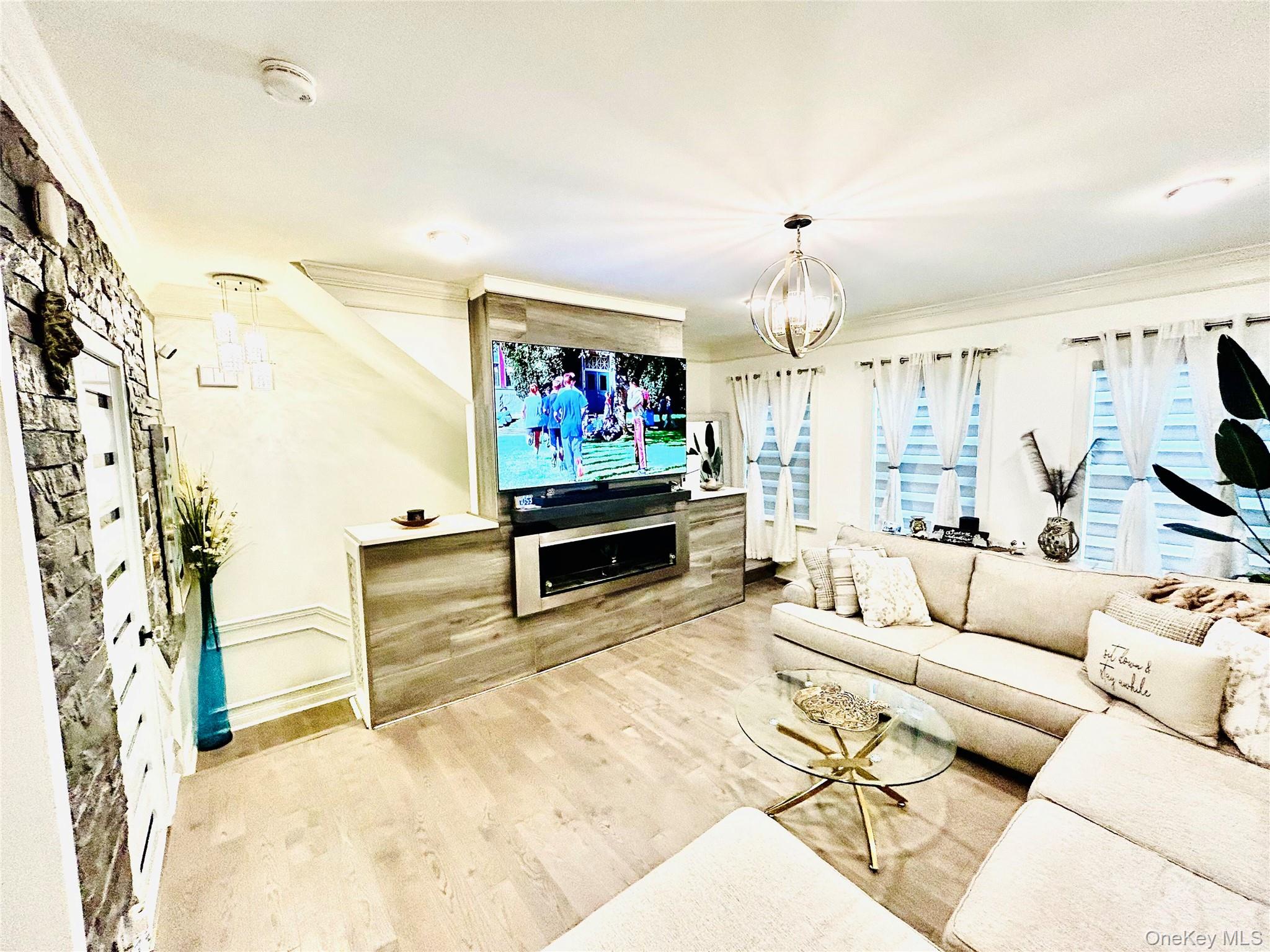 58 Rialto Way Patchogue, NY 11772 - Photo 21 of 40 a living room with furniture and a flat screen tv