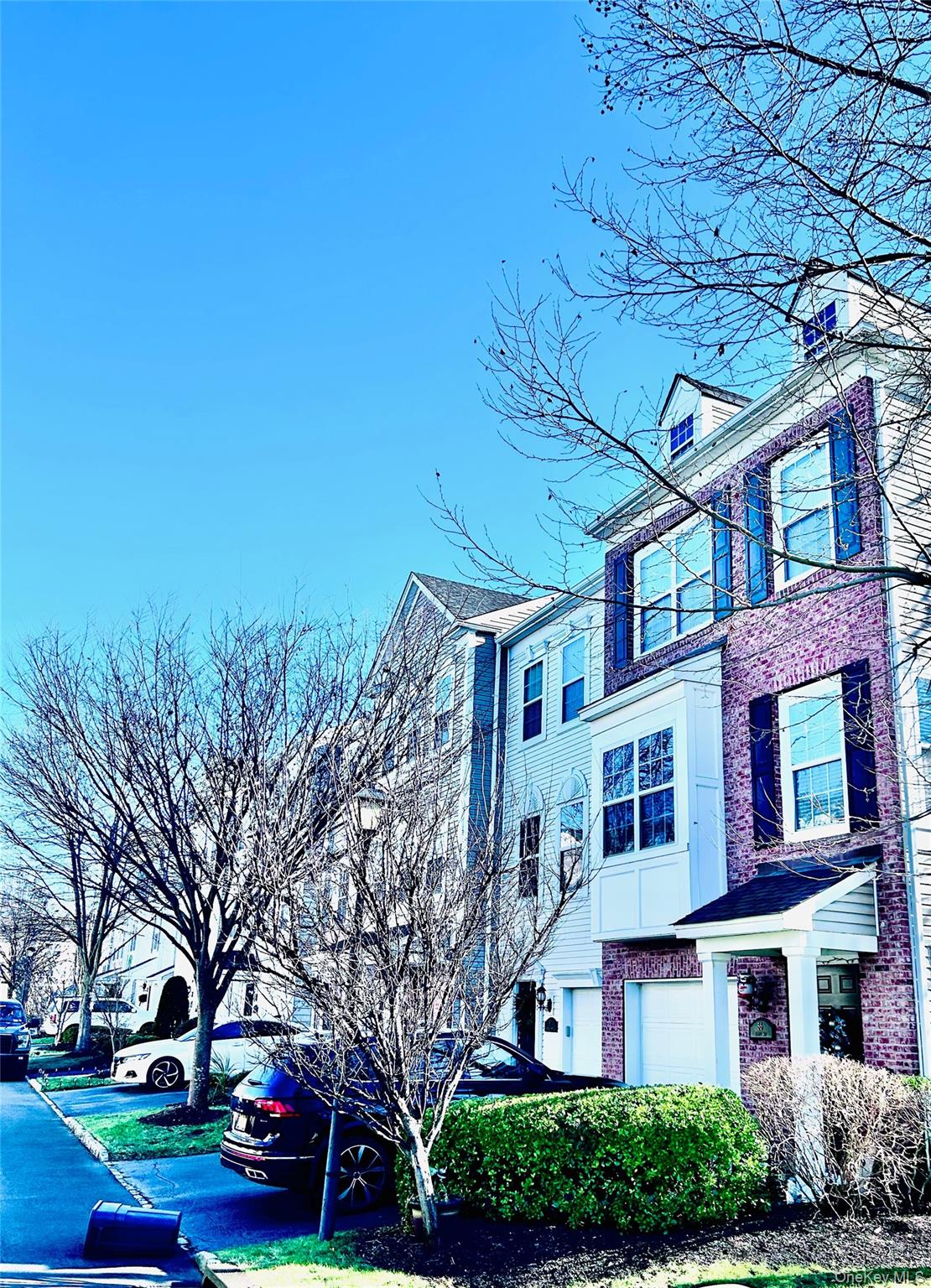 58 Rialto Way Patchogue, NY 11772 - Photo 3 of 40 a front view of a building with trees