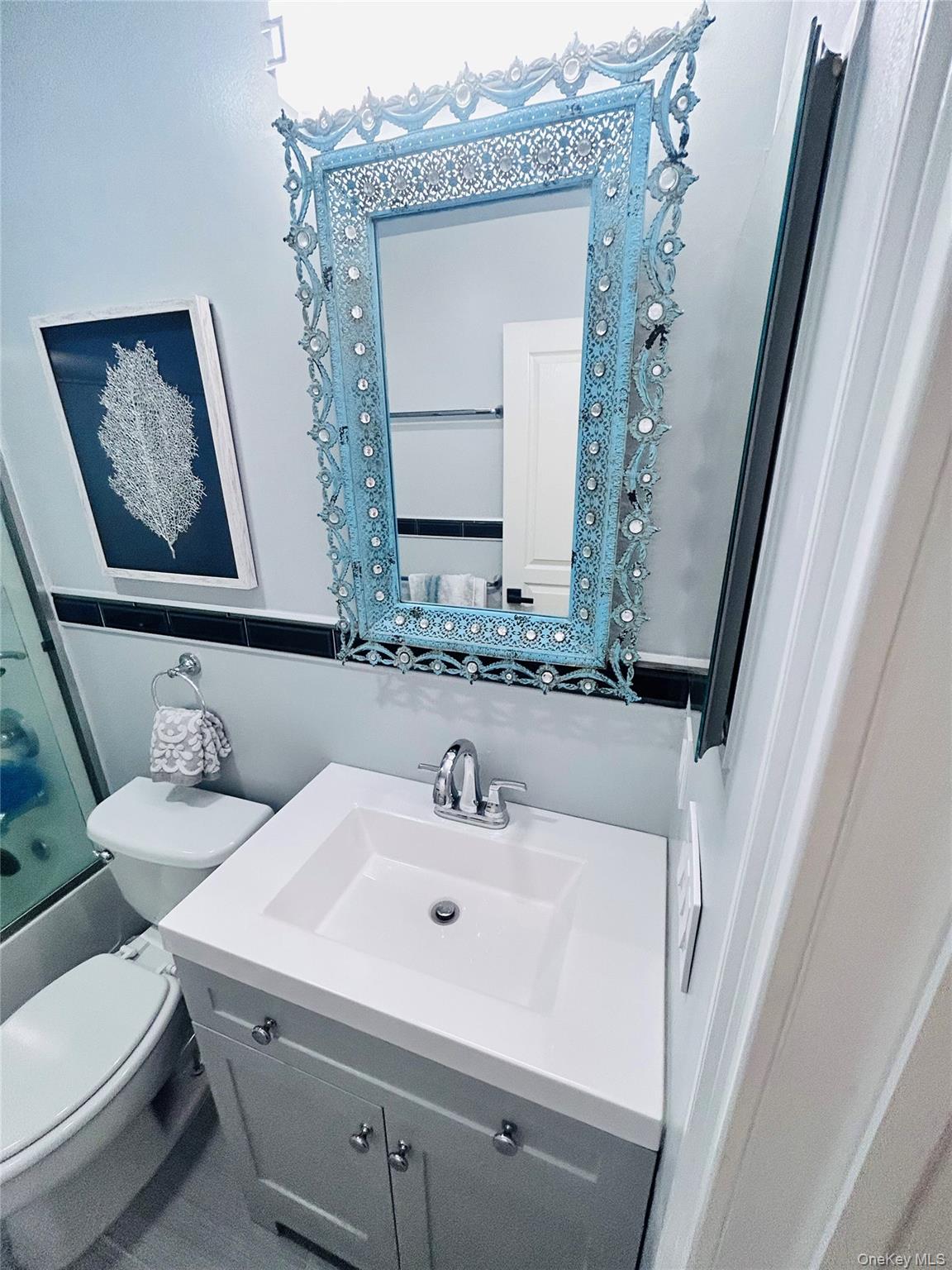58 Rialto Way Patchogue, NY 11772 - Photo 36 of 40 Bathroom featuring bath / shower combo with glass door and vanity