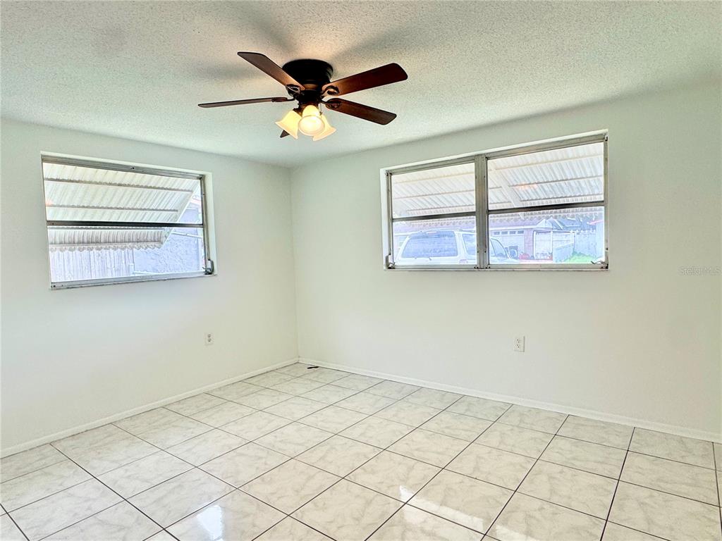 7235 Potomac Drive Port Richey, FL 34668 - Photo 10 of 23 a view of a big room with wooden floor and workspace