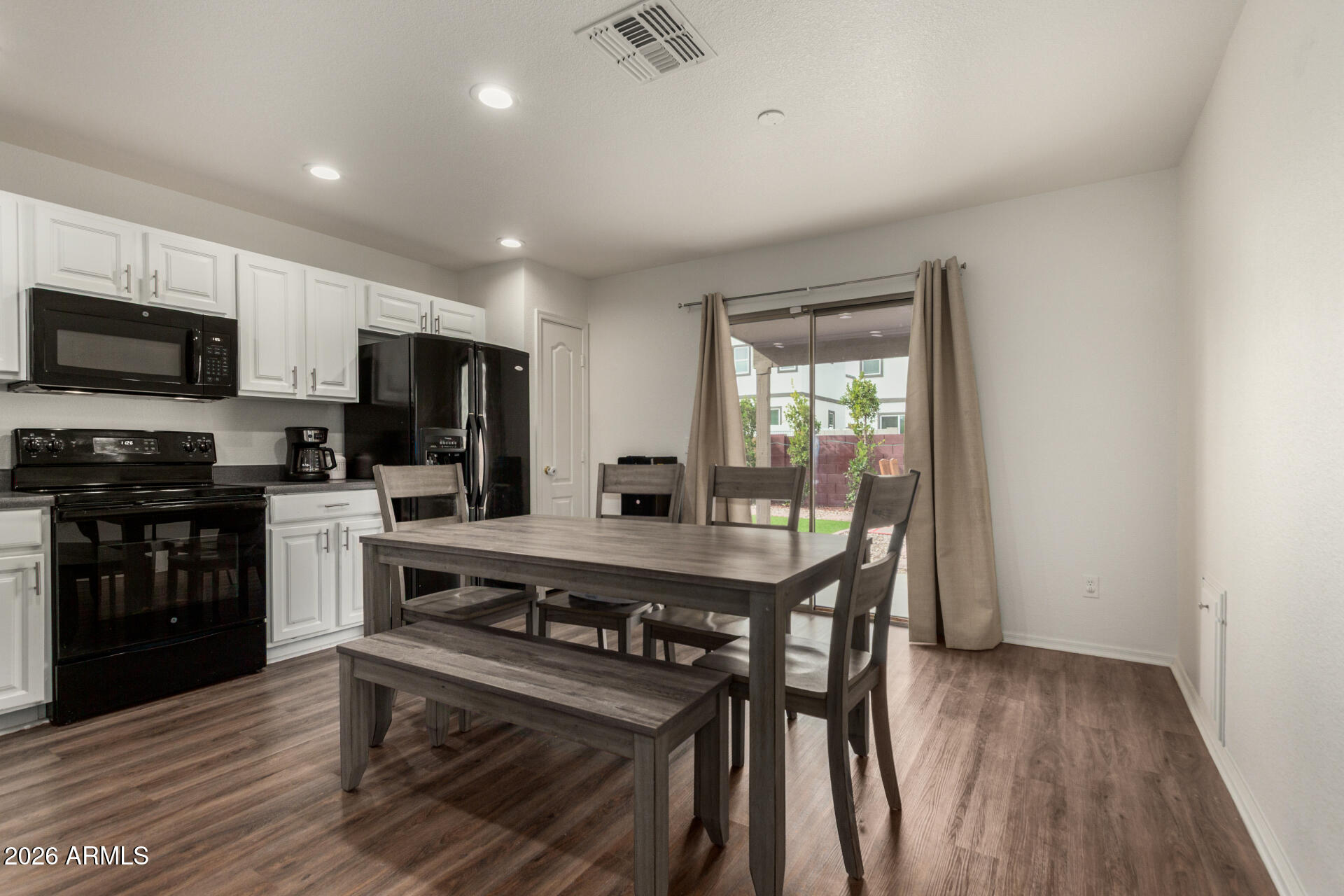 8806 South 9th Street Phoenix, AZ 85042 - Photo 11 of 31 a kitchen with stainless steel appliances a stove a refrigerator a sink and a microwave