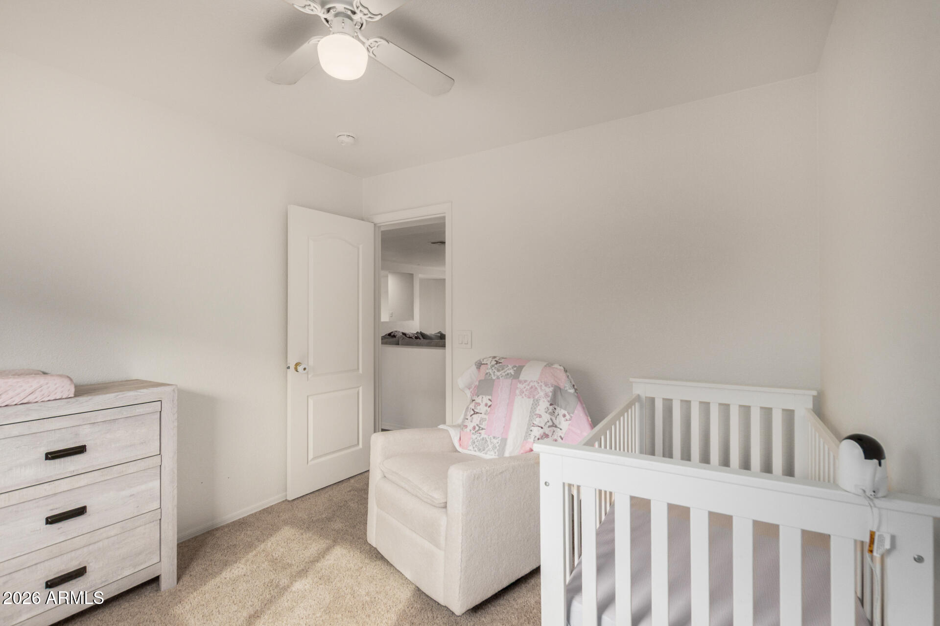 8806 South 9th Street Phoenix, AZ 85042 - Photo 21 of 31 a bedroom with a white bed and a chandelier
