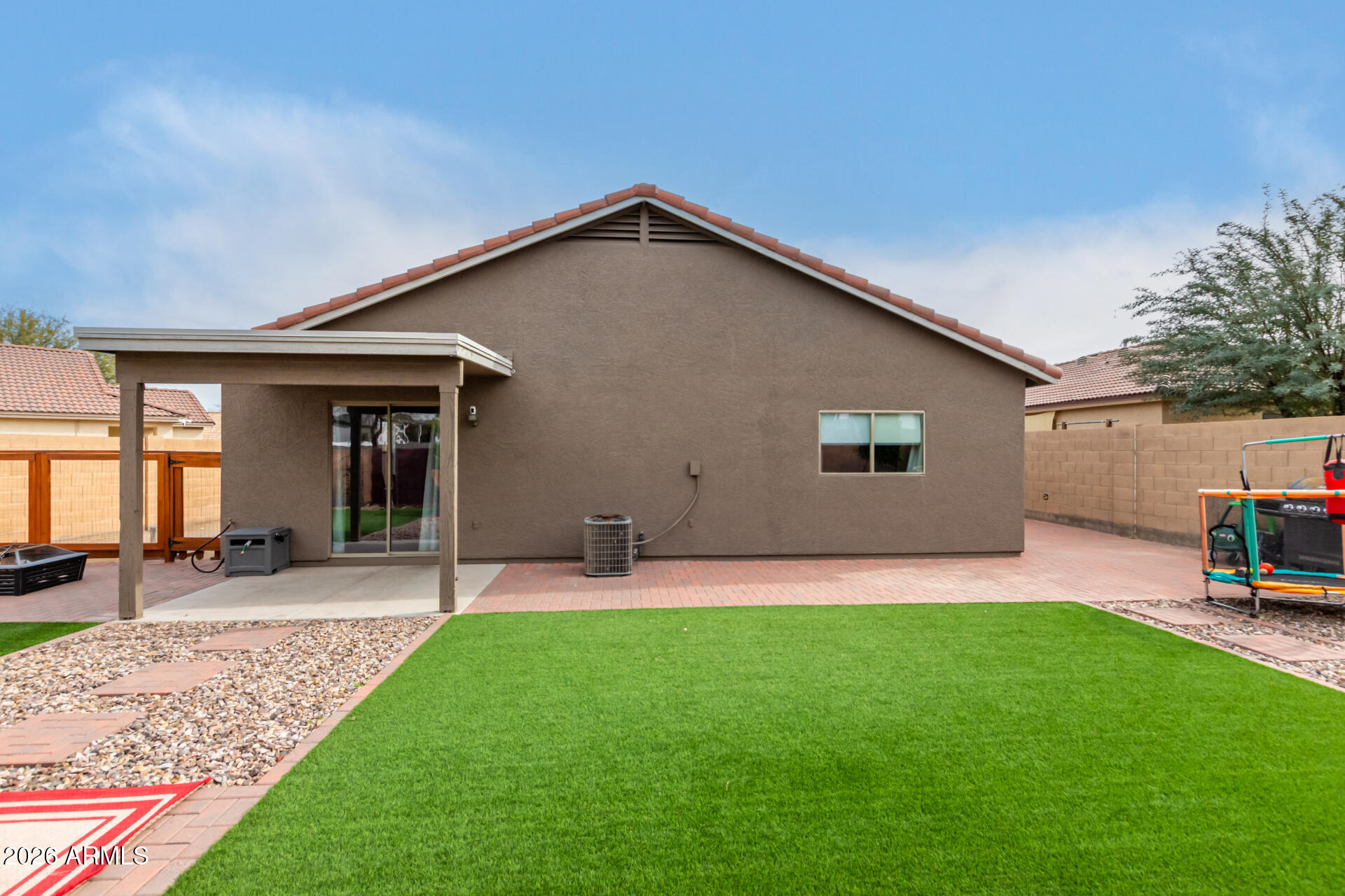 8806 South 9th Street Phoenix, AZ 85042 - Photo 29 of 31 a view of a backyard with table and chairs and large tree