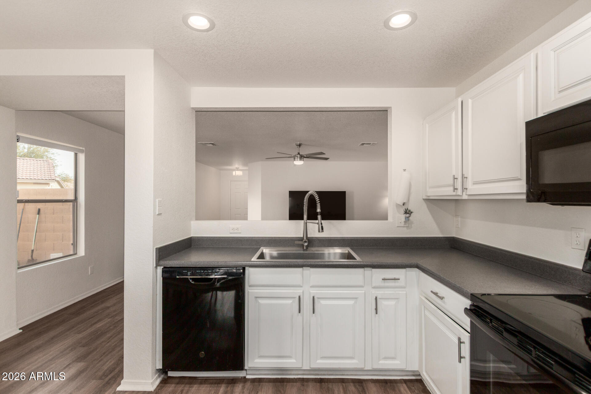 8806 South 9th Street Phoenix, AZ 85042 - Photo 10 of 31 a kitchen with granite countertop a sink dishwasher stove and cabinets