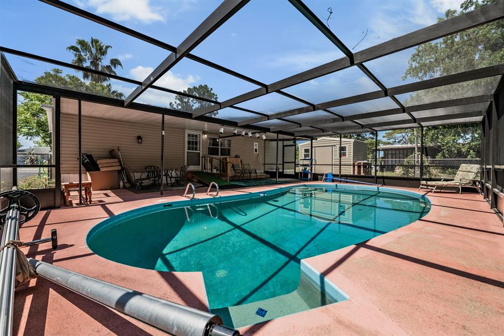 9739 Ray Street Hudson, FL 34669 - Photo 32 of 36 a view of a swimming pool with a patio