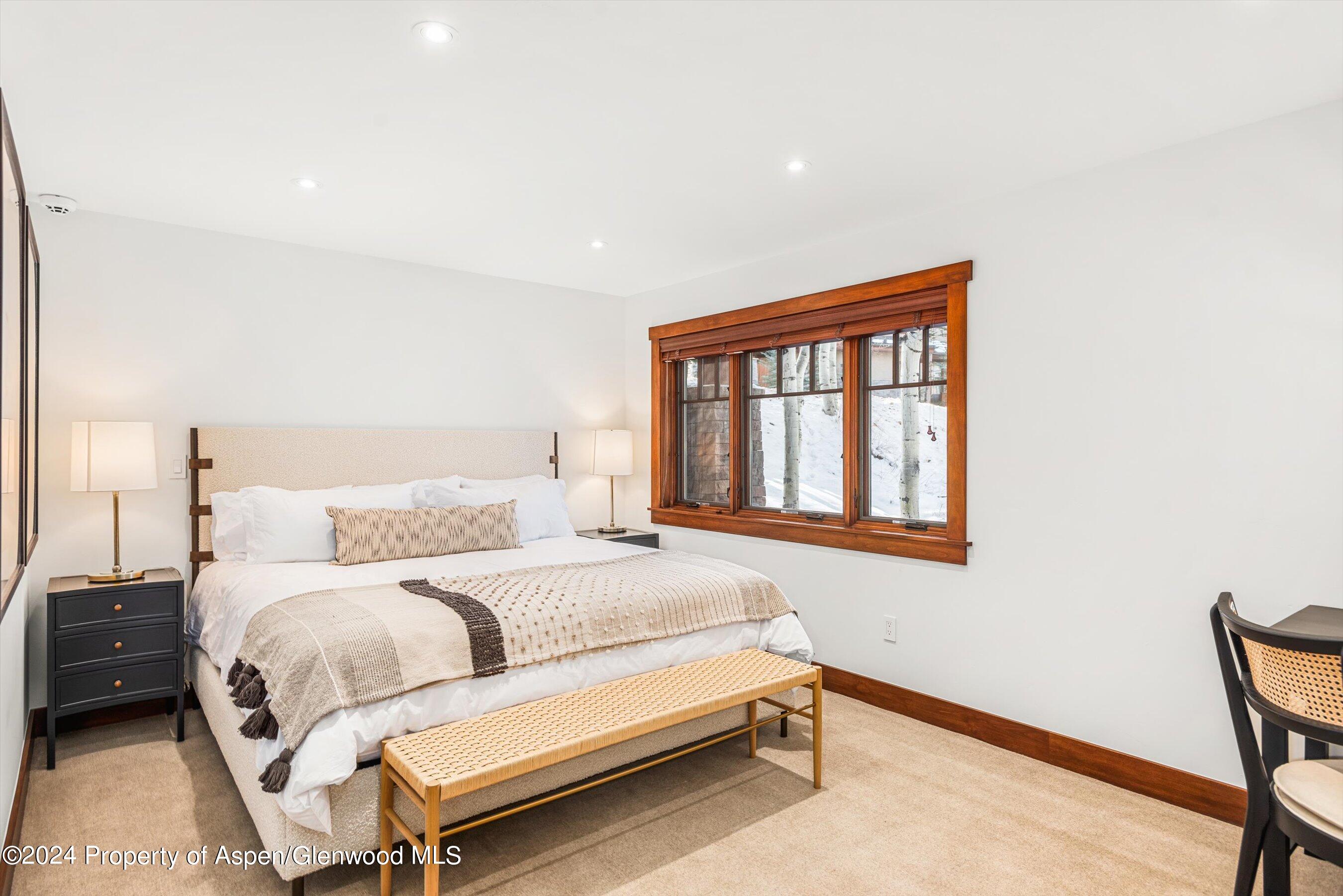227 Faraway Road, Unit 38 Snowmass Village, CO 81615 - Photo 29 of 71 a bedroom with a bed and a window