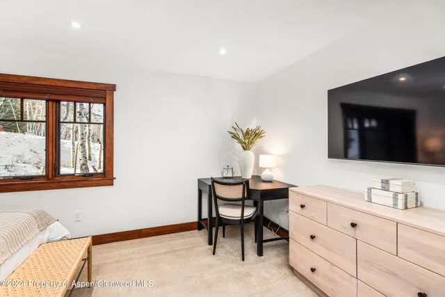 a view of a backyard with wooden fence and large trees