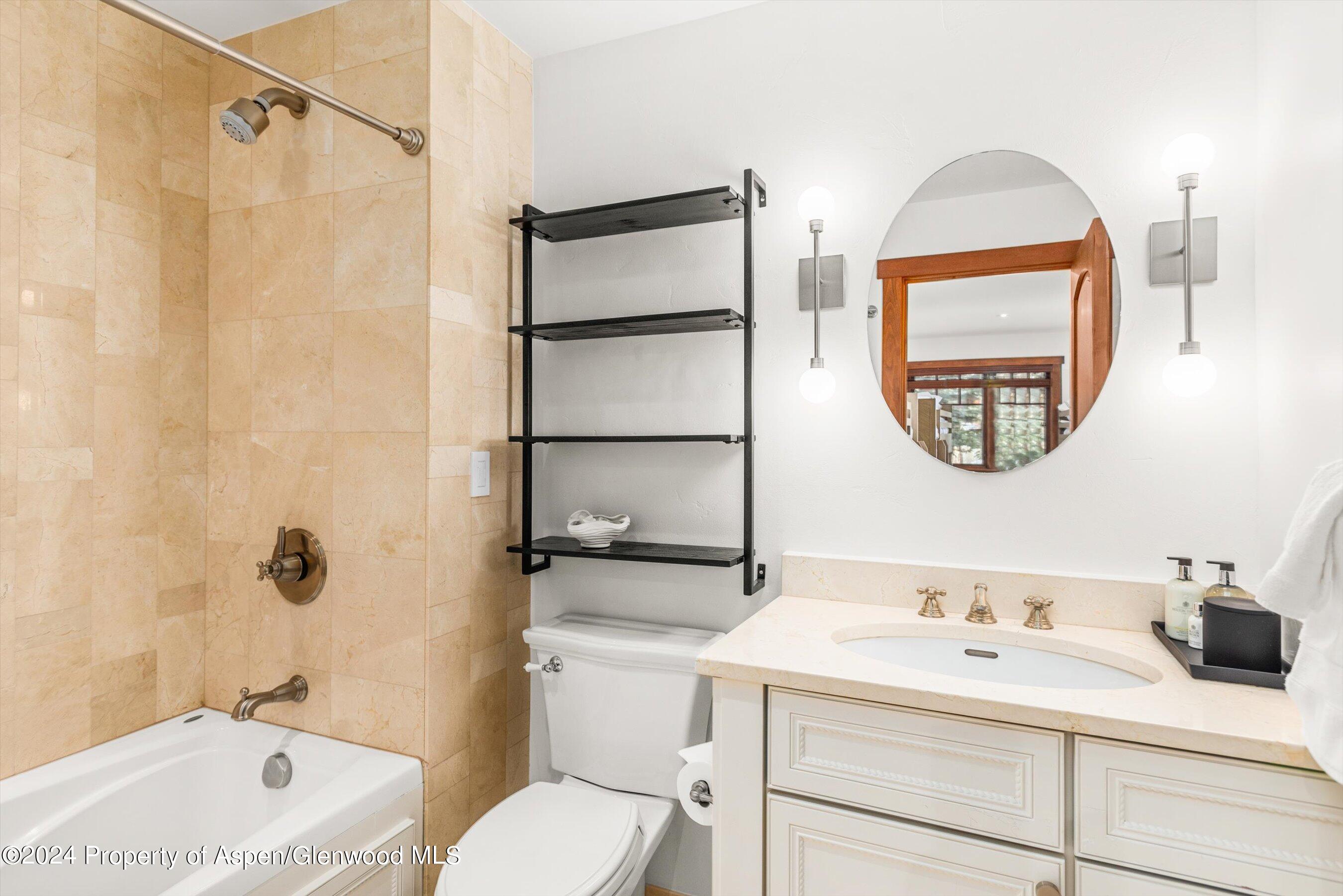 227 Faraway Road, Unit 38 Snowmass Village, CO 81615 - Photo 35 of 71 a bathroom with a sink a toilet and a mirror