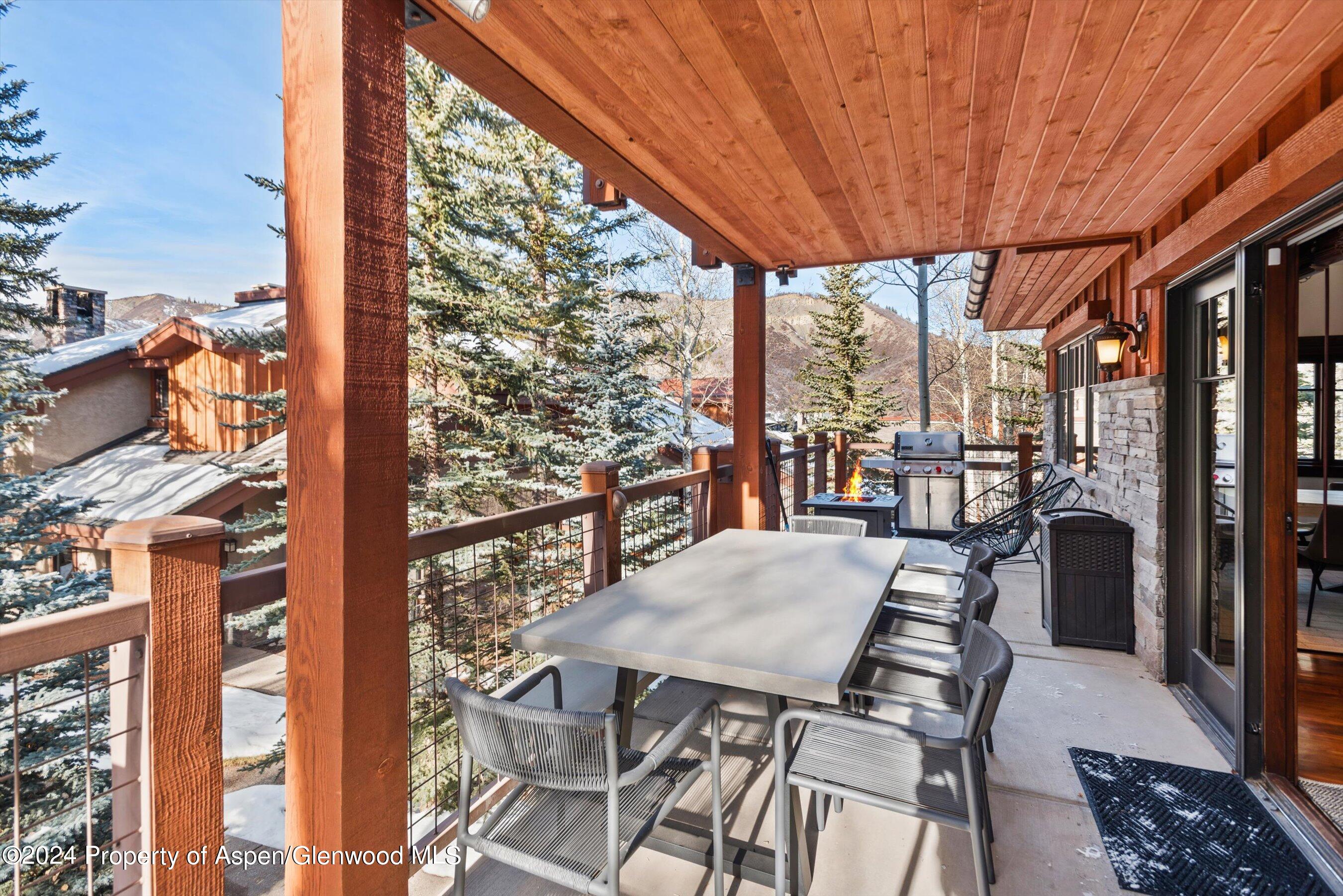 227 Faraway Road, Unit 38 Snowmass Village, CO 81615 - Photo 68 of 71 a view of a patio with a table chairs and a patio