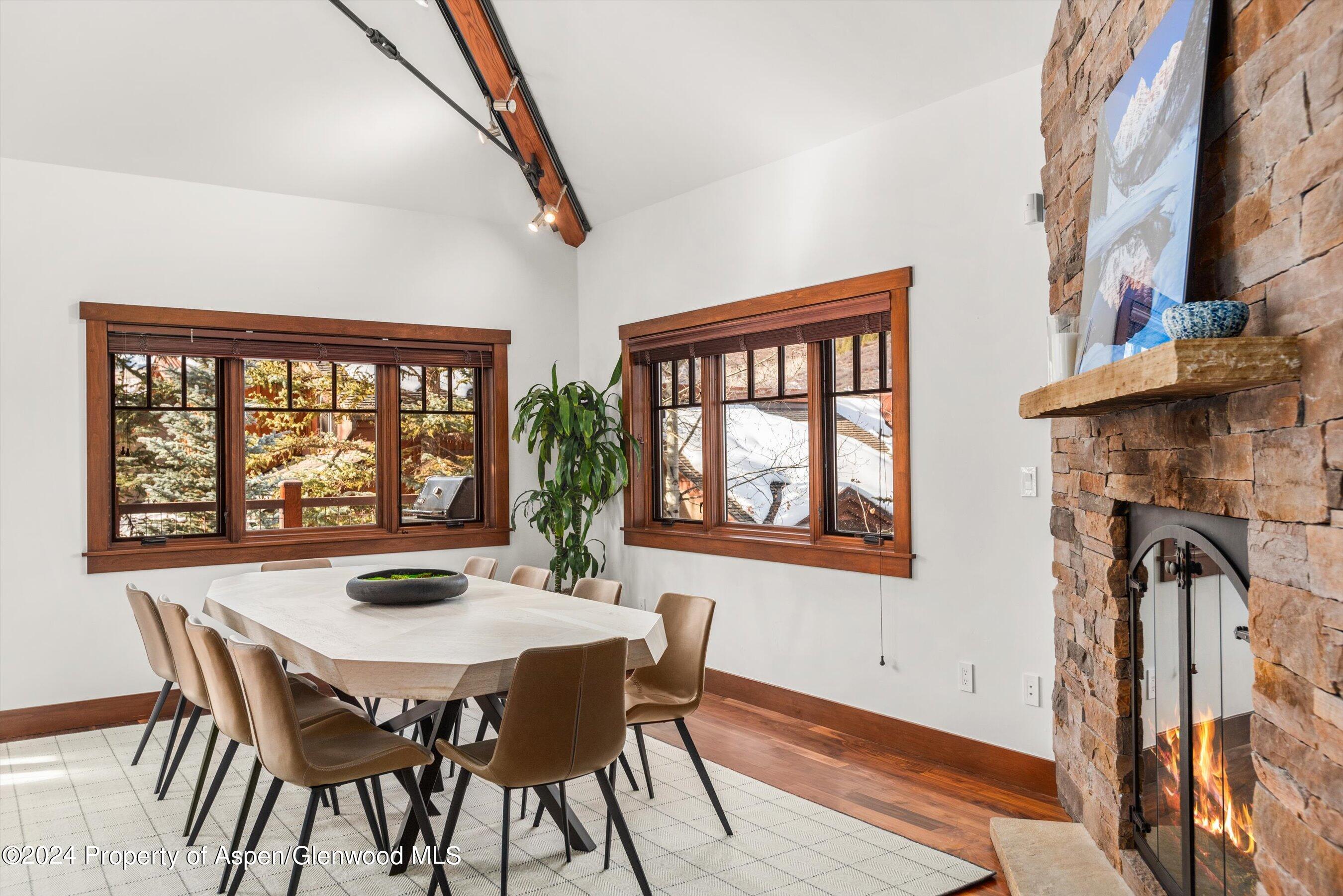227 Faraway Road, Unit 38 Snowmass Village, CO 81615 - Photo 10 of 71 a view of a dining room with furniture window and wooden floor