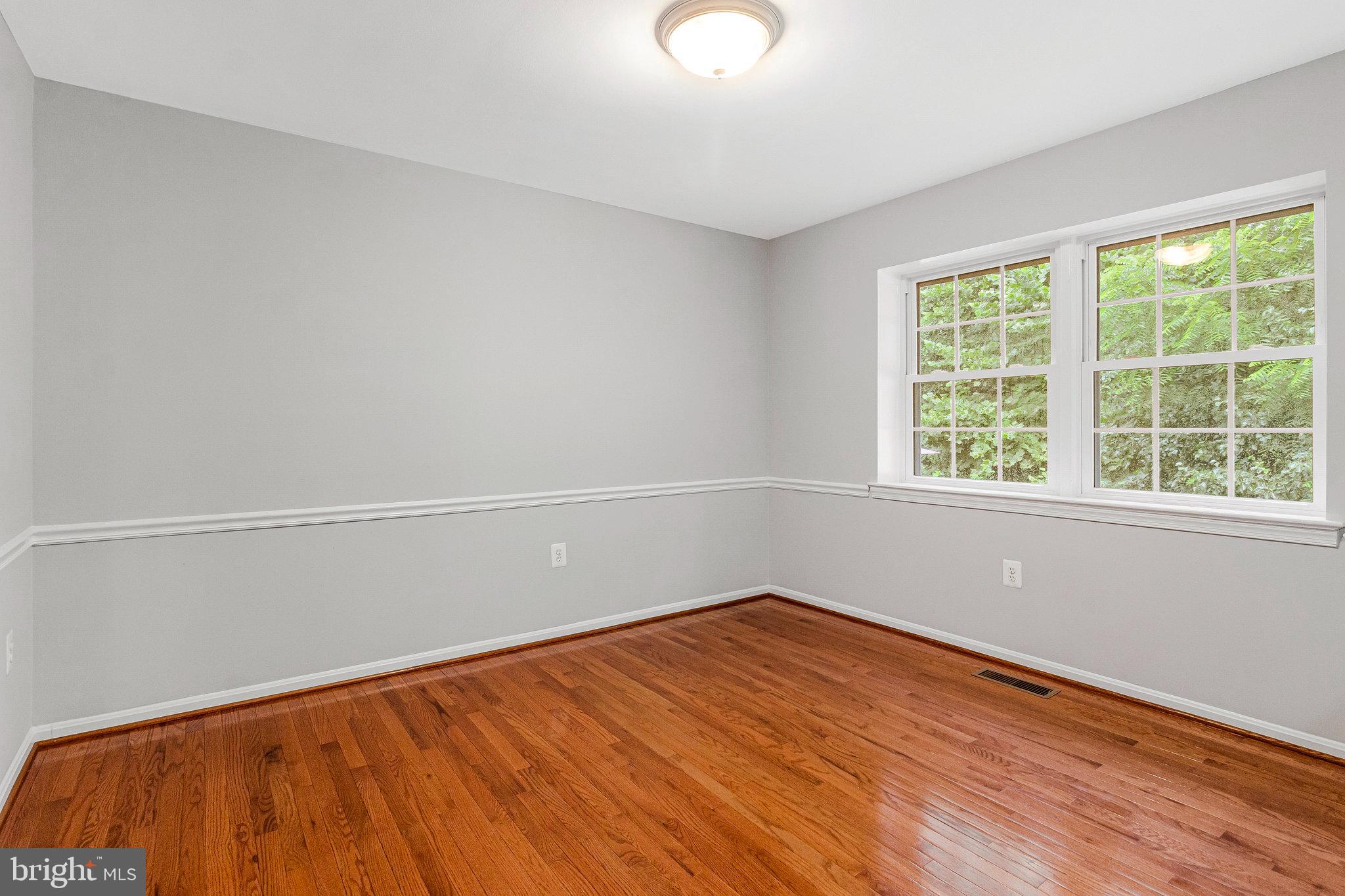 8020 Sleepy View Lane Springfield, VA 22153 - Photo 11 of 53 a view of empty room with wooden floor and fan