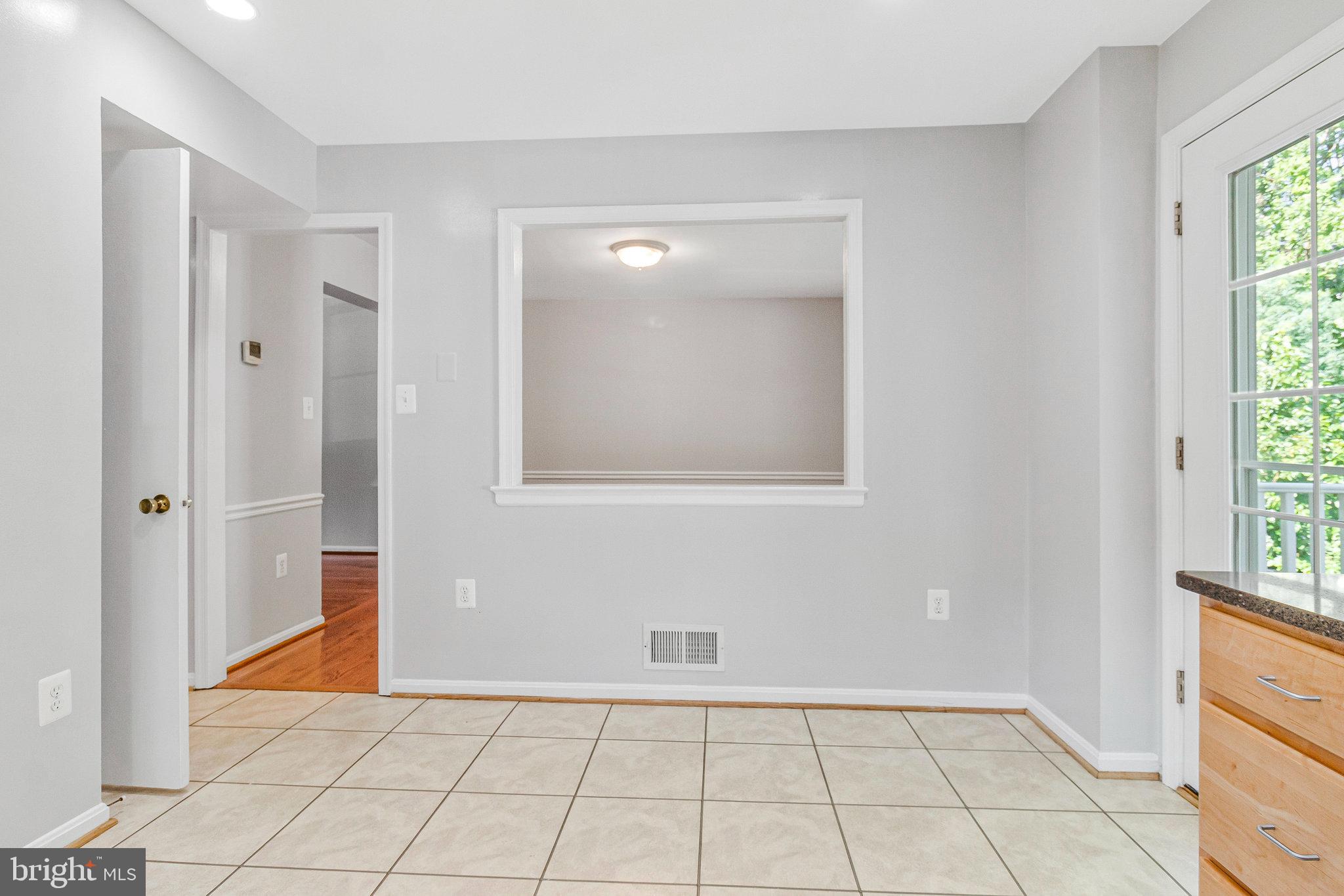 8020 Sleepy View Lane Springfield, VA 22153 - Photo 15 of 53 a view of an empty room with window and chandelier fan
