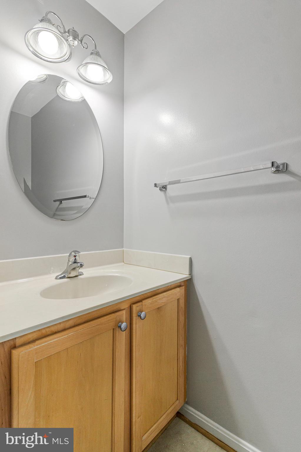 8020 Sleepy View Lane Springfield, VA 22153 - Photo 19 of 53 a bathroom with a sink and mirror