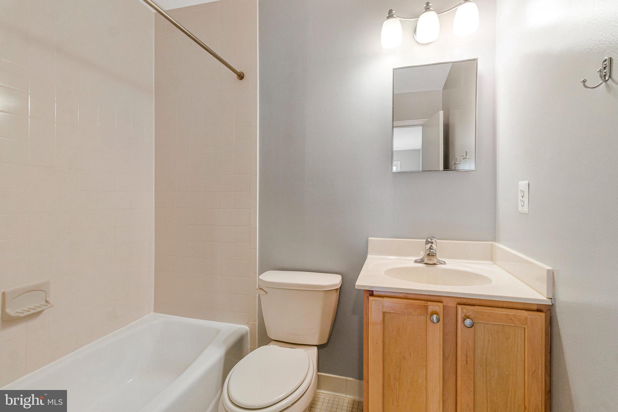 8020 Sleepy View Lane Springfield, VA 22153 - Photo 22 of 53 a bathroom with a toilet sink and mirror