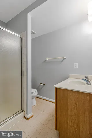 a bathroom with a glass shower door