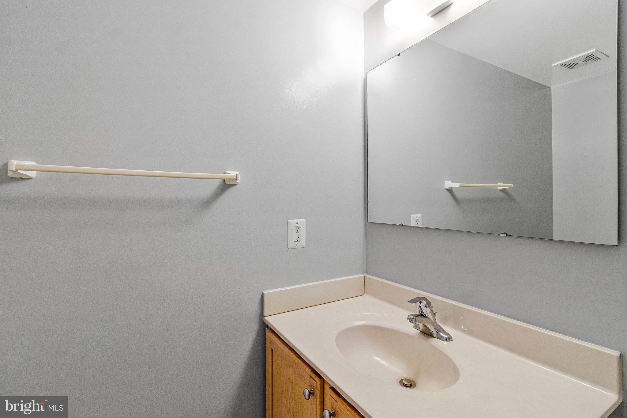 8020 Sleepy View Lane Springfield, VA 22153 - Photo 40 of 53 a bathroom with a sink and mirror