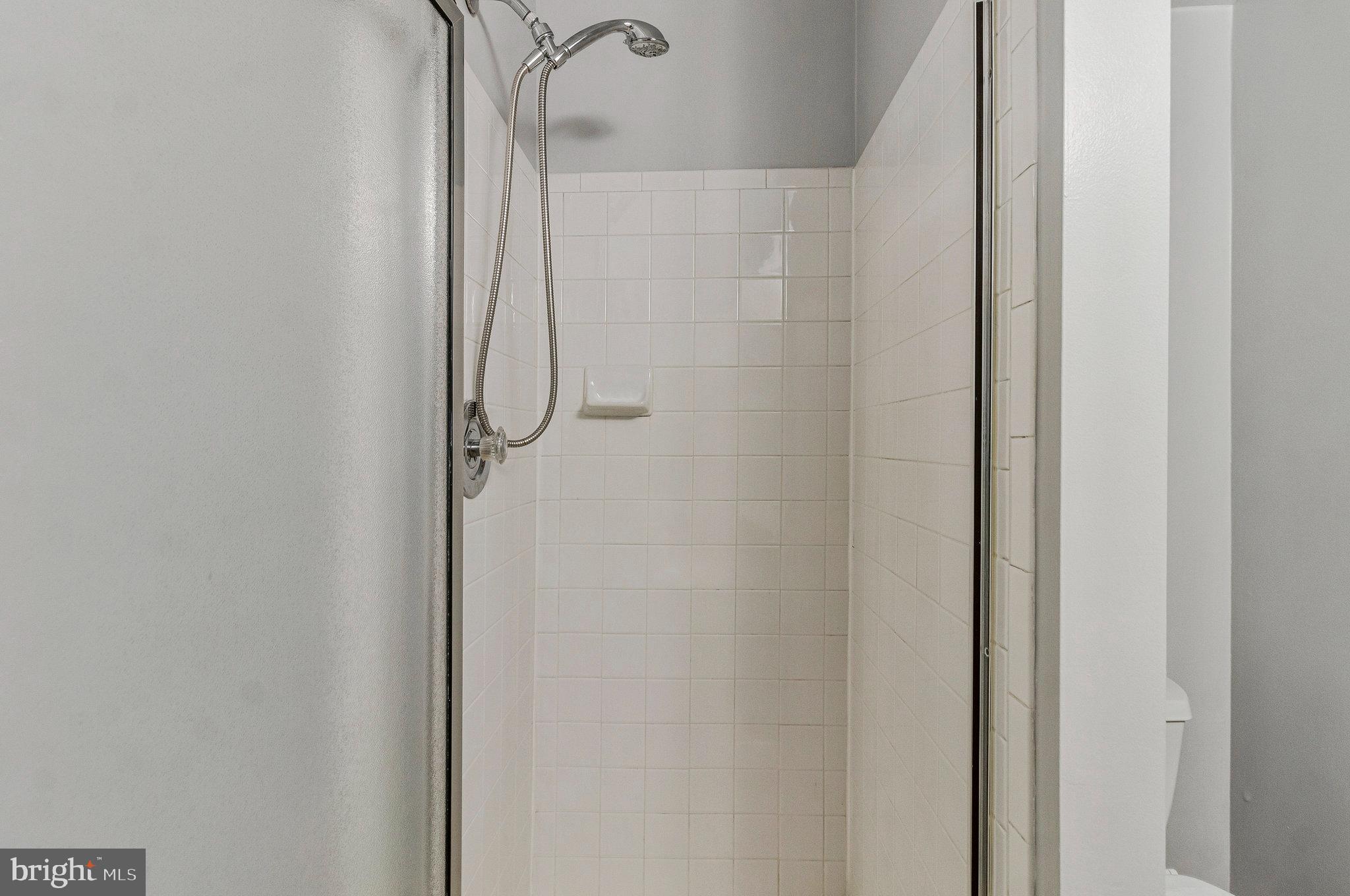 8020 Sleepy View Lane Springfield, VA 22153 - Photo 41 of 53 a bathroom with a glass shower door